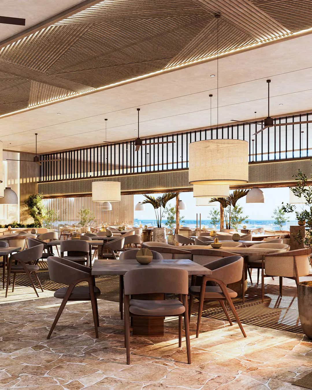 Restaurant dining room with timber chairs, woven pendant lights and an ocean view
